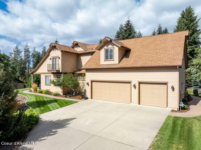 view of front of house featuring a front yard and a garage