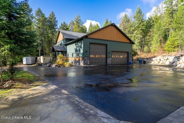 exterior space featuring a garage and an outbuilding