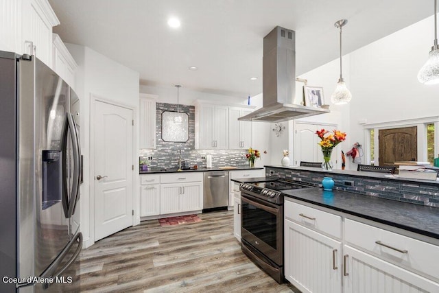 kitchen featuring white cabinets, stainless steel appliances, island range hood, and pendant lighting