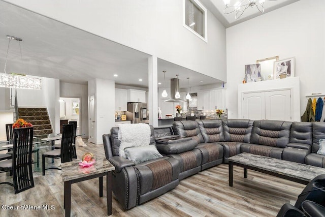 living room featuring light hardwood / wood-style floors and a chandelier