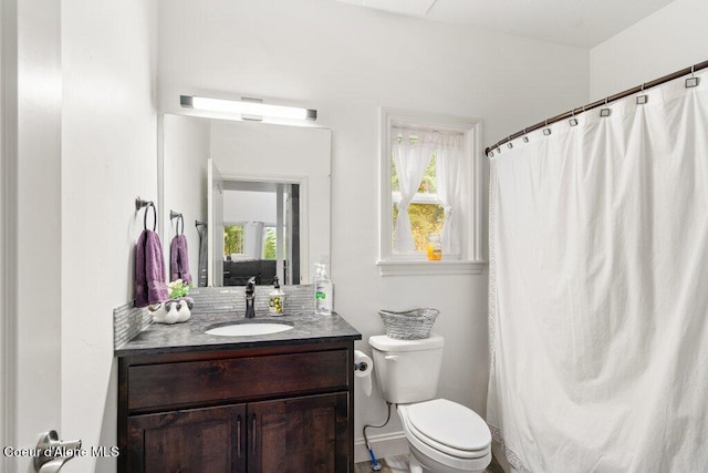 bathroom featuring vanity, toilet, and a shower with shower curtain