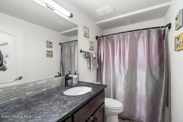 bathroom featuring vanity, decorative backsplash, a shower with curtain, and toilet