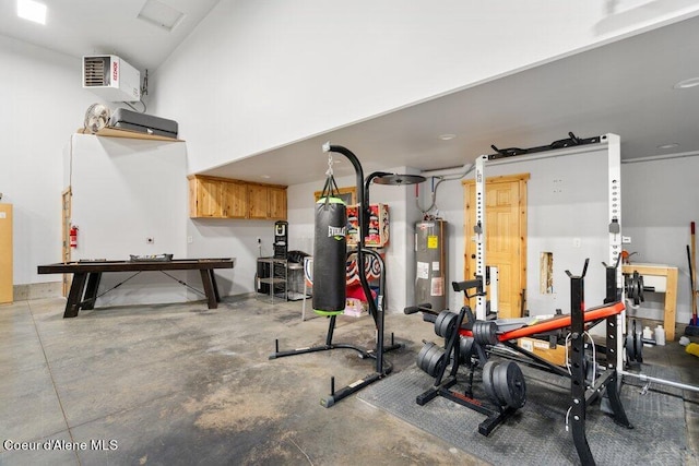 workout room with concrete floors and electric water heater