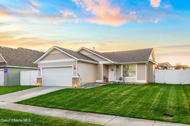 view of front of property featuring a garage and a lawn