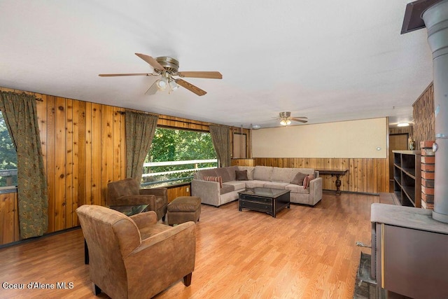 905 S Tanglewood Rd, Post Falls, ID 83854 - living room with ceiling fan, wood walls, wood finished floors, and a wainscoted wall