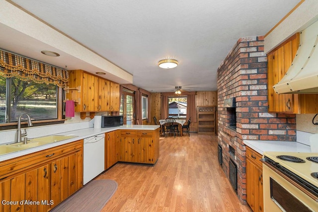 905 S Tanglewood Rd, Post Falls, ID 83854 - kitchen featuring white dishwasher, range, black microwave, a peninsula, and a sink
