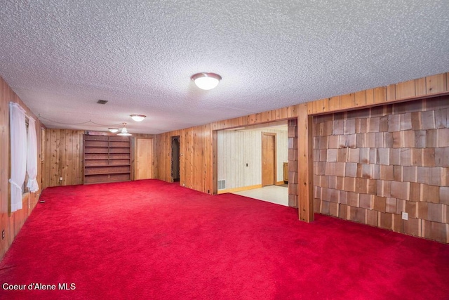 905 S Tanglewood Rd, Post Falls, ID 83854 - finished basement with wood walls, carpet flooring, and a textured ceiling