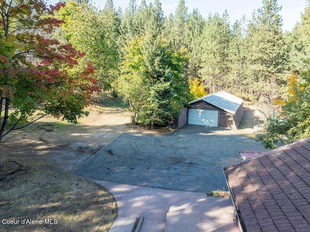 905 S Tanglewood Rd, Post Falls, ID 83854 - view of yard with an outdoor structure and a garage