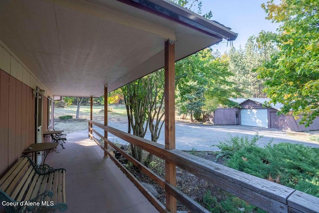 905 S Tanglewood Rd, Post Falls, ID 83854 - covered porch featuring driveway and an outdoor structure