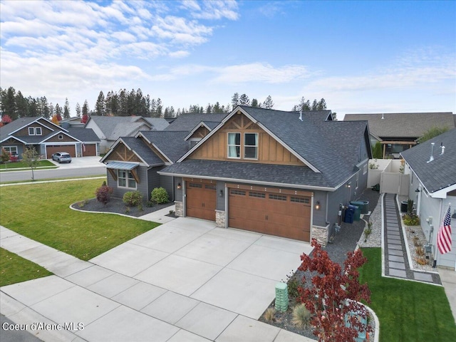 craftsman-style home featuring central air condition unit, a front lawn, and a garage