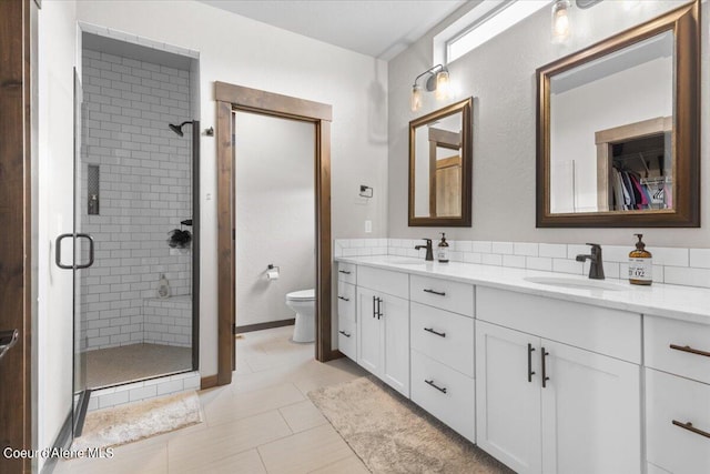 bathroom with vanity, toilet, tile patterned floors, and an enclosed shower