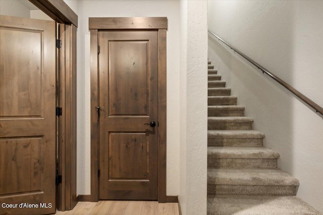 stairs with hardwood / wood-style flooring