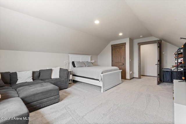 carpeted bedroom featuring lofted ceiling