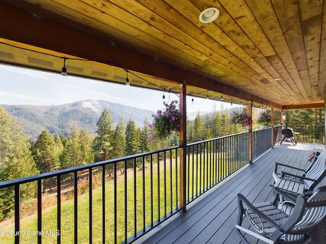 deck featuring a yard and a mountain view