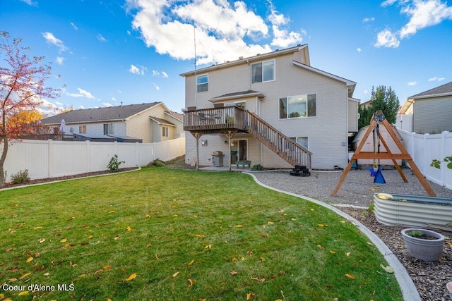 back of property with a wooden deck, a lawn, and a playground