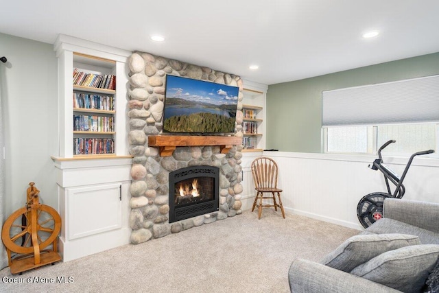 carpeted living room featuring a fireplace