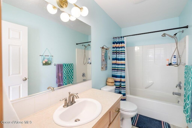 full bathroom with vanity, shower / bath combo, and toilet