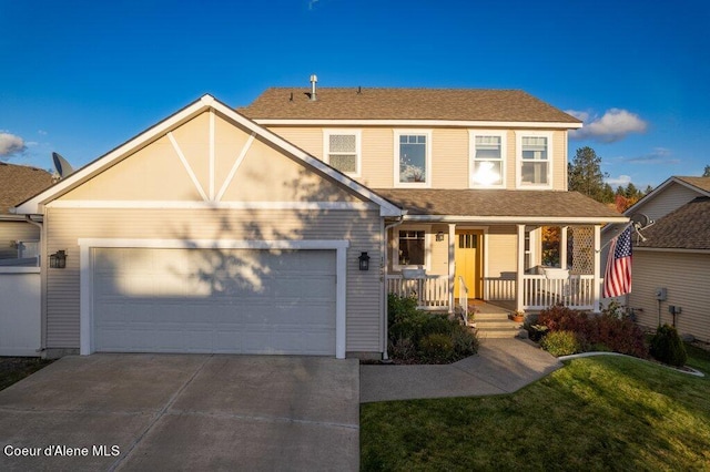 view of front facade with a front yard, a porch, and a garage