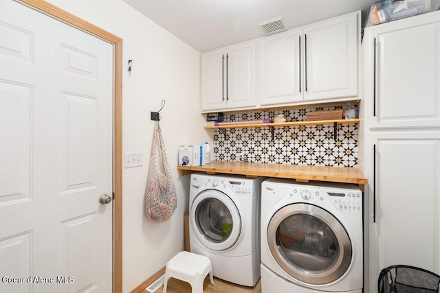 laundry area featuring cabinets and washer and clothes dryer