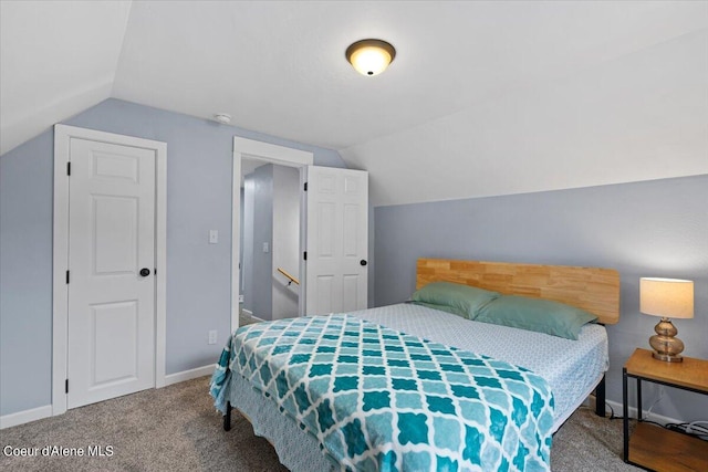 carpeted bedroom featuring lofted ceiling