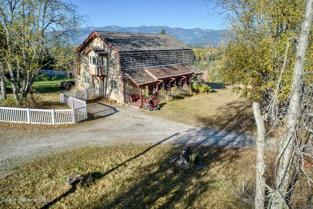 exterior space featuring a mountain view and a yard