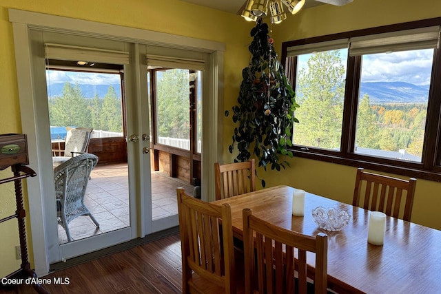 dining space with a mountain view, dark hardwood / wood-style floors, and ceiling fan