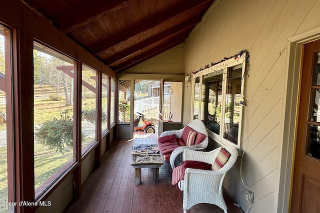 sunroom with vaulted ceiling, wooden ceiling, and plenty of natural light