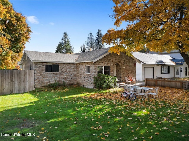 rear view of house featuring a yard and a patio