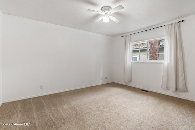 empty room featuring ceiling fan and carpet