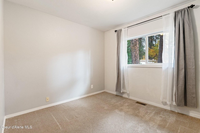 unfurnished room featuring carpet