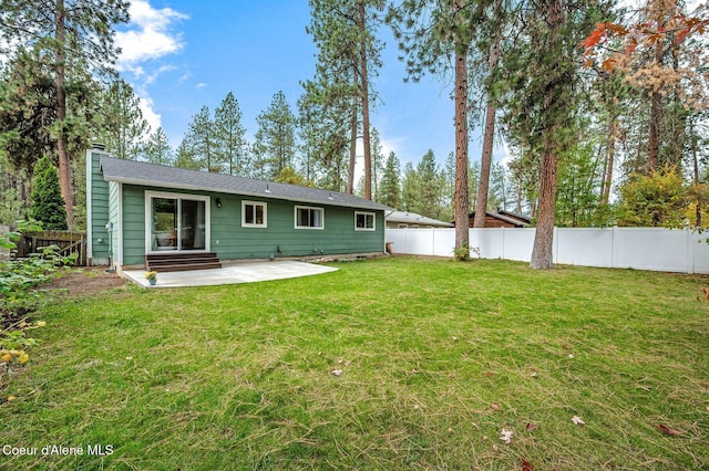 back of property with a patio and a yard