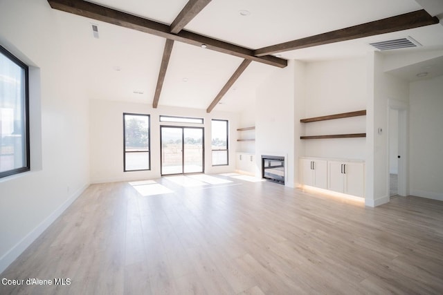 unfurnished living room with light hardwood / wood-style floors, high vaulted ceiling, and beamed ceiling