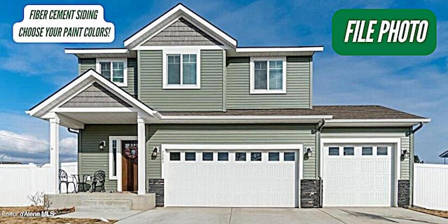 2711 E Cinder Ave, Post Falls, ID 83854 - craftsman inspired home featuring stone siding, an attached garage, and concrete driveway