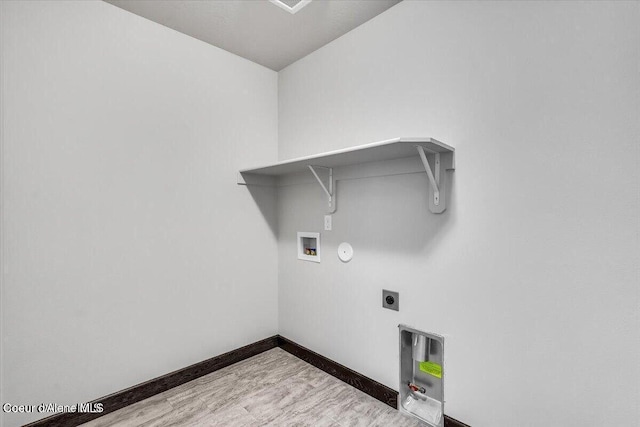2711 E Cinder Ave, Post Falls, ID 83854 - laundry area with hookup for an electric dryer, hookup for a gas dryer, washer hookup, baseboards, and wood finished floors