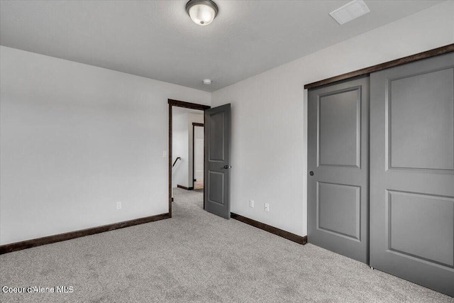 2711 E Cinder Ave, Post Falls, ID 83854 - unfurnished bedroom with carpet flooring, baseboards, and a closet
