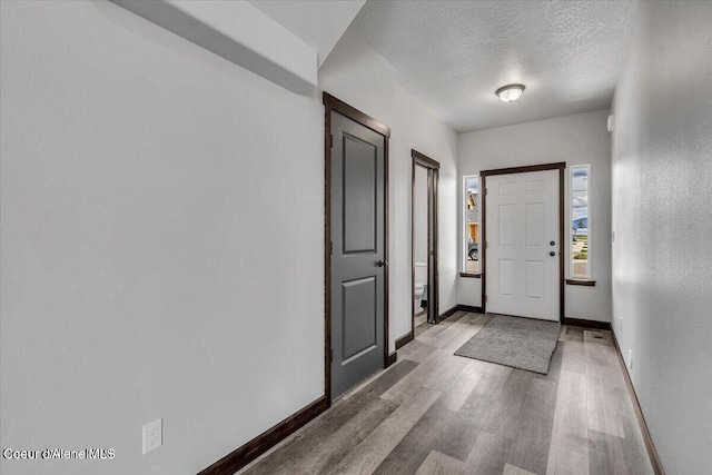 2711 E Cinder Ave, Post Falls, ID 83854 - foyer with wood finished floors, baseboards, and a textured ceiling