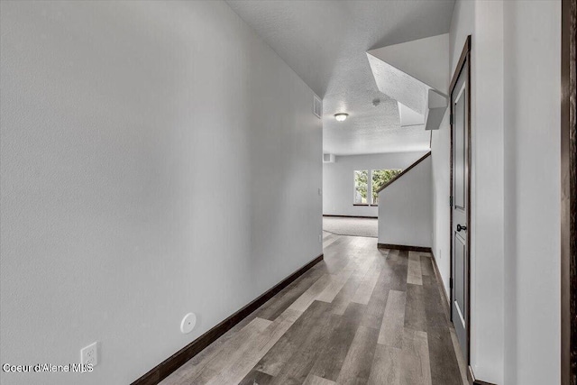 2711 E Cinder Ave, Post Falls, ID 83854 - corridor with a textured ceiling, wood finished floors, and baseboards