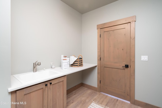 11996 N Rocking R, Hayden, ID 83835 - laundry room with a sink and light wood-style flooring