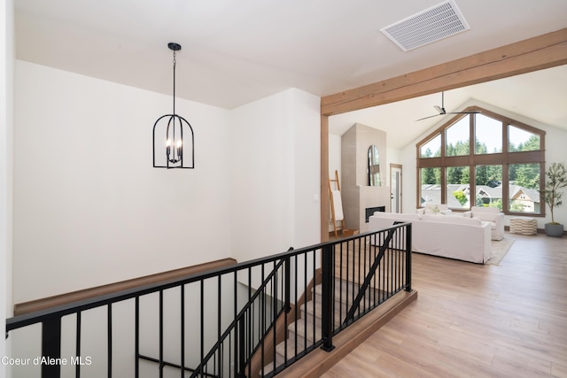 11996 N Rocking R, Hayden, ID 83835 - hallway with an upstairs landing, wood finished floors, a chandelier, and vaulted ceiling