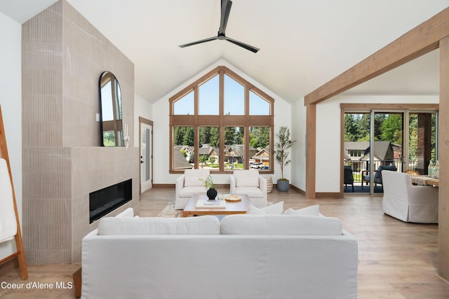 11996 N Rocking R, Hayden, ID 83835 - living room featuring ceiling fan, a fireplace, light wood-style floors, and high vaulted ceiling