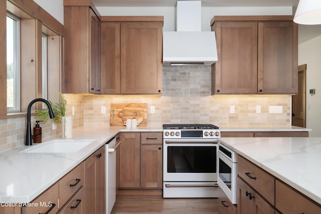 11996 N Rocking R, Hayden, ID 83835 - kitchen with white appliances, premium range hood, light stone counters, backsplash, and wood finished floors