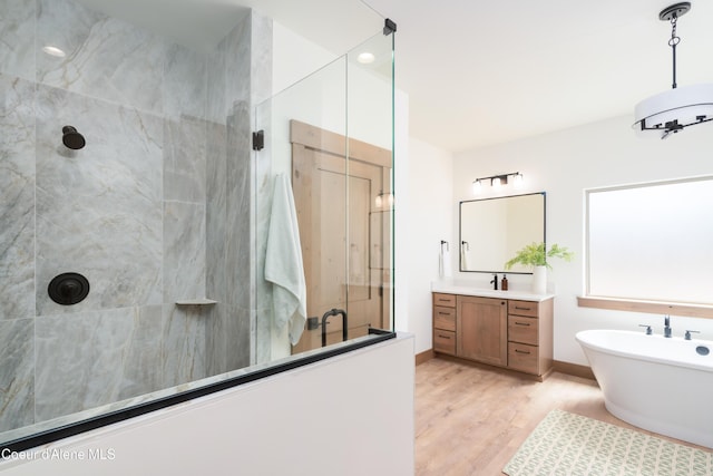 11996 N Rocking R, Hayden, ID 83835 - full bath featuring a shower with shower door, vanity, a freestanding bath, and wood finished floors