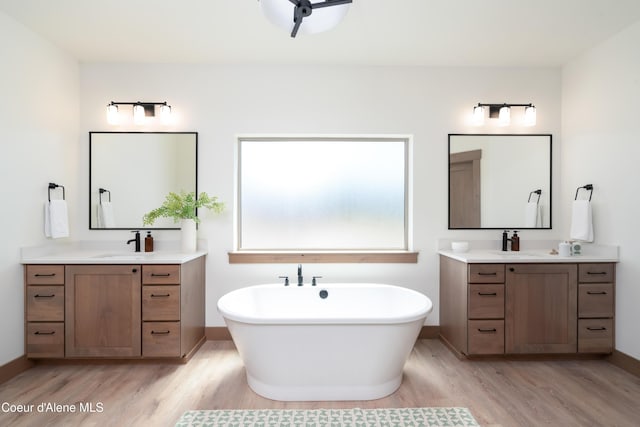 11996 N Rocking R, Hayden, ID 83835 - bathroom with wood finished floors, two vanities, and a freestanding tub