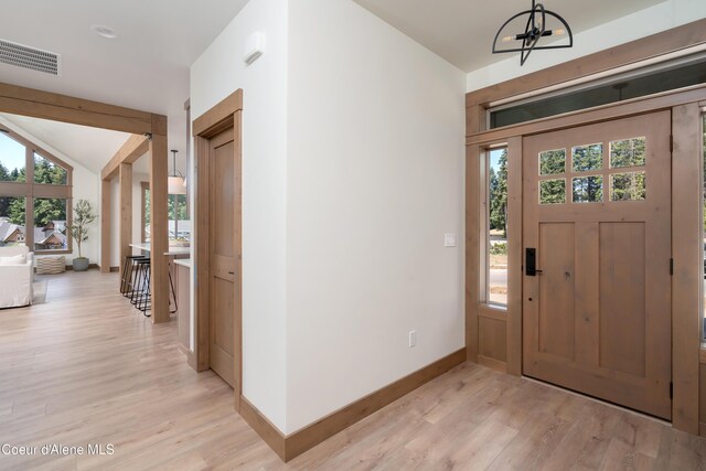 11996 N Rocking R, Hayden, ID 83835 - entryway featuring light wood-style flooring, a chandelier, and vaulted ceiling