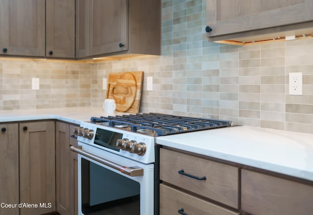 11996 N Rocking R, Hayden, ID 83835 - kitchen with white range with gas stovetop, tasteful backsplash, and light countertops