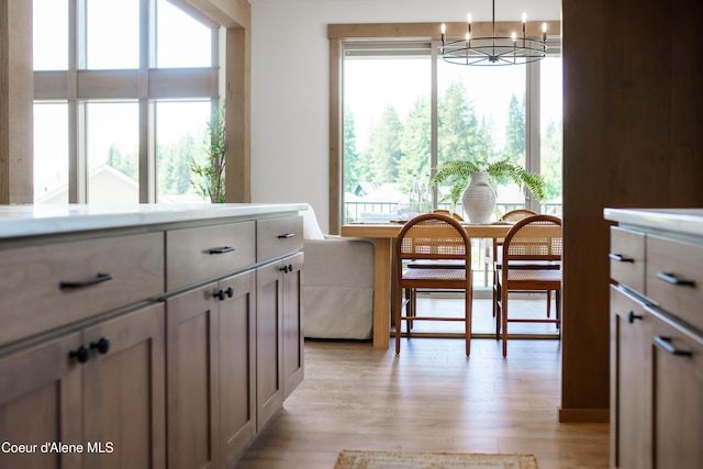 11996 N Rocking R, Hayden, ID 83835 - dining area with a chandelier, light wood-style flooring, and healthy amount of natural light
