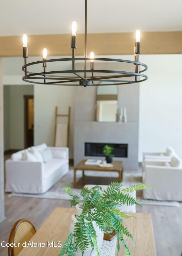 11996 N Rocking R, Hayden, ID 83835 - living room featuring a chandelier, wood finished floors, and a glass covered fireplace