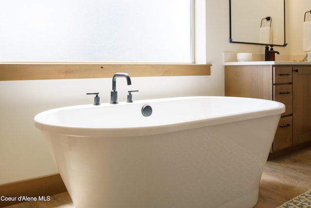 11996 N Rocking R, Hayden, ID 83835 - full bath featuring vanity, a soaking tub, and wood finished floors