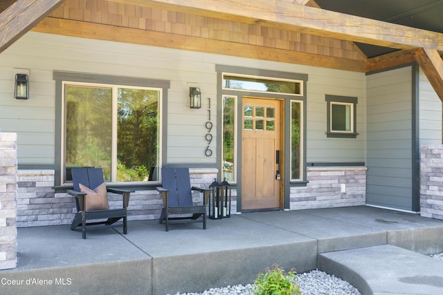 11996 N Rocking R, Hayden, ID 83835 - view of exterior entry with covered porch and stone siding