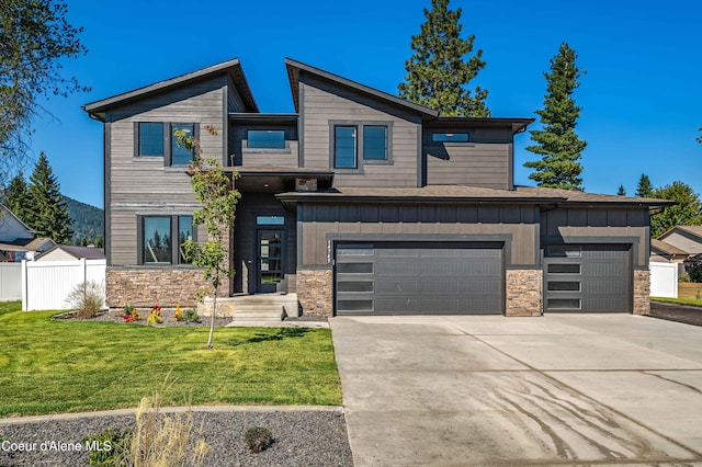 contemporary house featuring a front yard and a garage